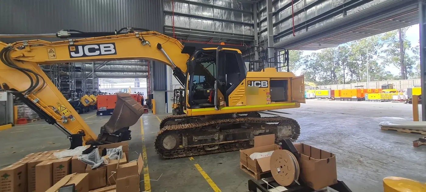 JCB excavator in a service bay for heavy diesel servicing